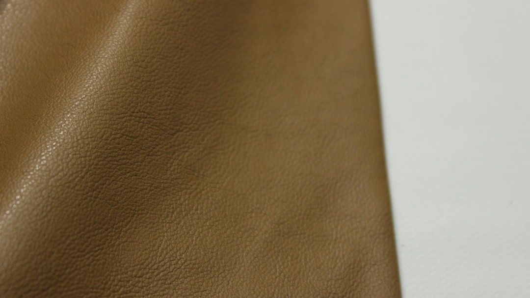 An application scenario or product detail of brown fake leather fabric - Image 11