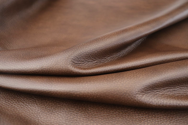 An application scenario or product detail of brown leather upholstery fabric - Image 19