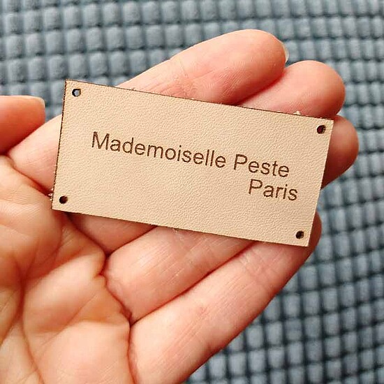 An application scenario or product detail of custom leather tags - Image 17